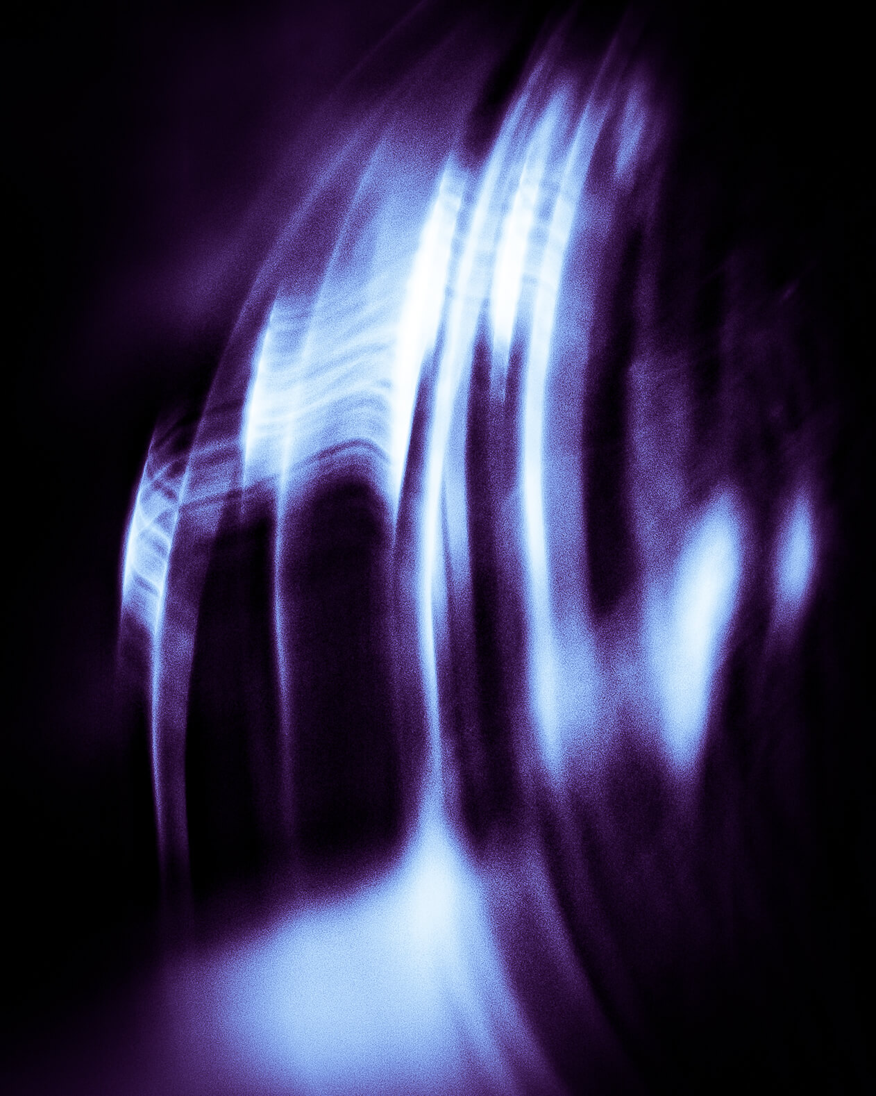 An abstract photograph of blue light on a black background